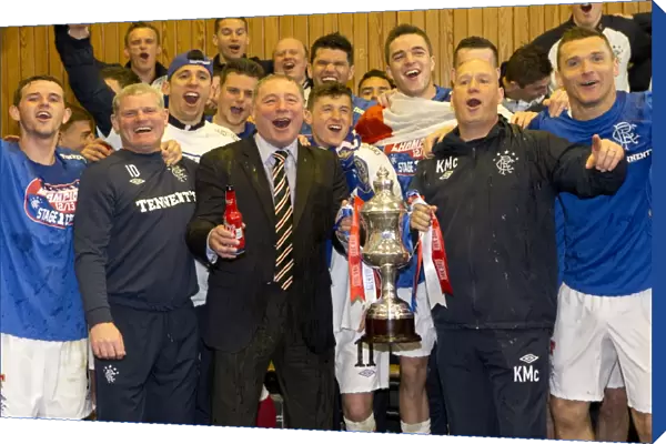 Rangers players and management celebrate with the Irn Bru Third Division trophy in the dressing room