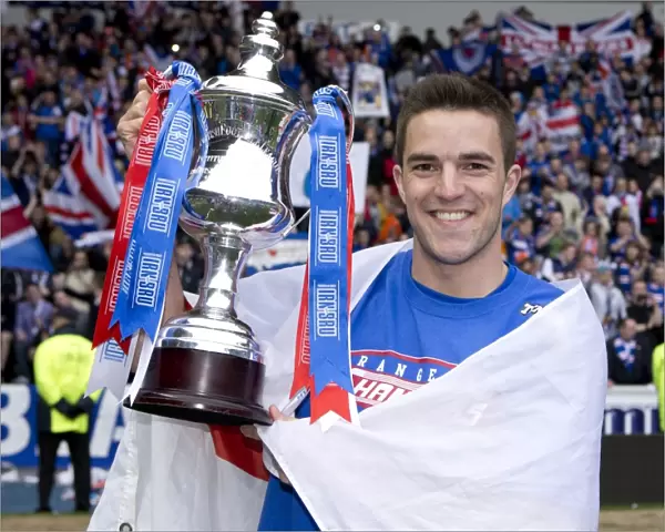 Rangers FC Claims Irn-Bru Scottish Third Division Title: Andy Little's Triumphant Moment with the Trophy at Ibrox Stadium