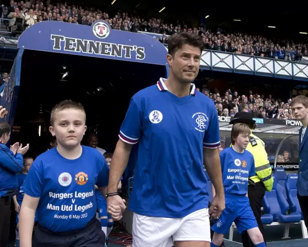 A Classic Soccer Showdown at Ibrox Stadium: Rangers Legends vs Manchester United Legends - Brian Laudrup and the Rangers Mascot: Unforgettable Clash of Soccer Greats