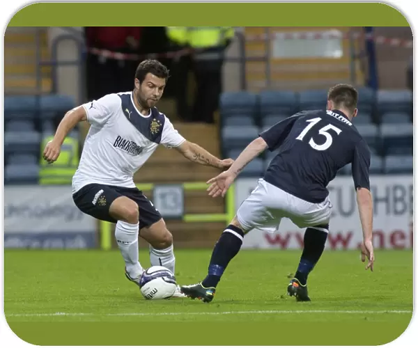 Rangers Richard Foster Outmaneuvers Dundee's Carlo Monti in Thrilling 1-1 Friendly Clash at Dens Park