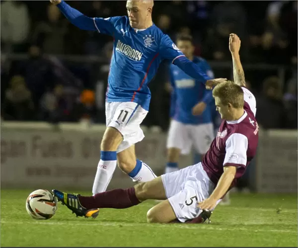 Rangers Nicky Law Repels Arbroath's Michael Travis in Scottish League One Battle