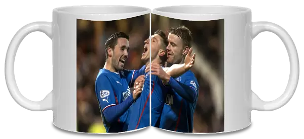 Rangers Aird, Clark, and Smith: Jubilant Moment as They Celebrate Goal in Scottish League One Against Dunfermline Athletic