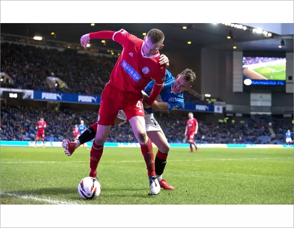 Intense Battle for the Ball: Dean Shiels vs Graham Hay - Scottish League One Rivalry at Ibrox Stadium