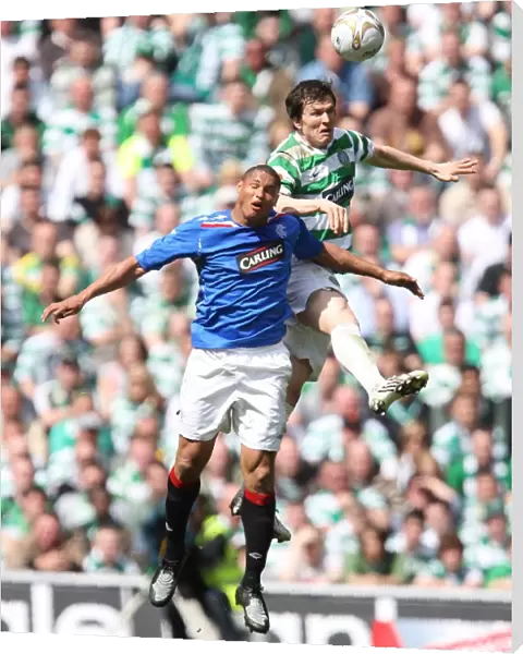 Intense Rivalry: Clydesdale Bank Premier League - Celtic vs Rangers: Aerial Battle Between Daniel Cousin and Gary Caldwell (3-2 in Favor of Celtic)
