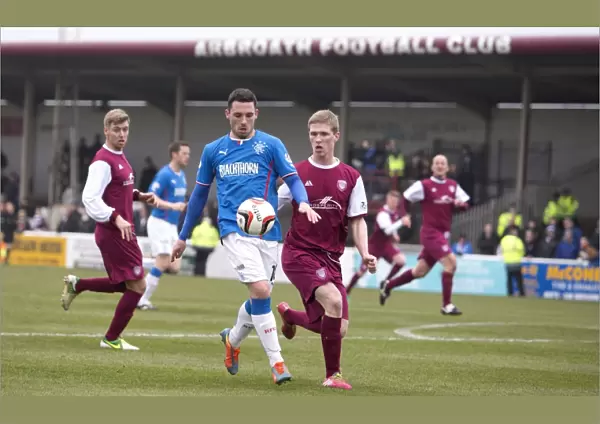 Rangers Nicky Clark Faces Off Against Arbroath's Colin Hamilton at Gayfield Park, Scottish League One