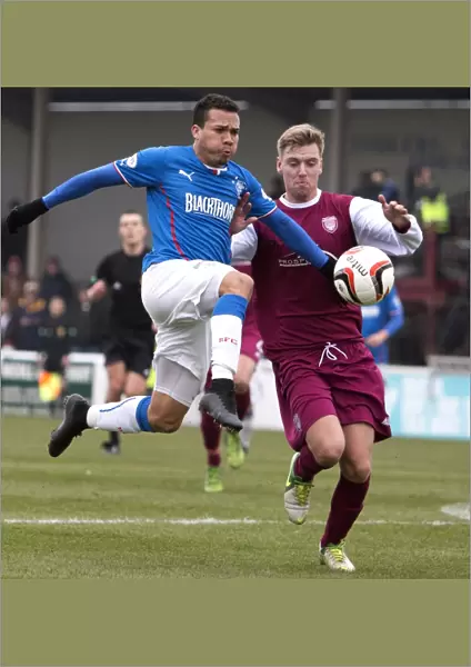 Intense Rivalry: Peralta and Travis Clash for Ball in Rangers vs Arbroath Scottish League One Match