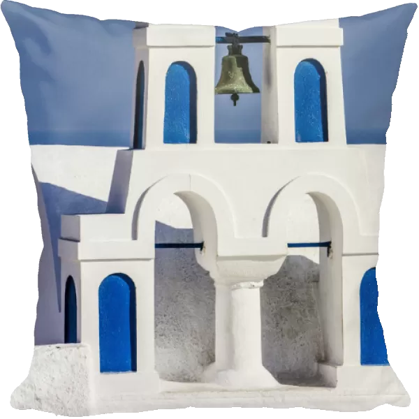 Oia, Greece. Greek Orthdox Church steeple, cross, bell, and blue arches against Aegean