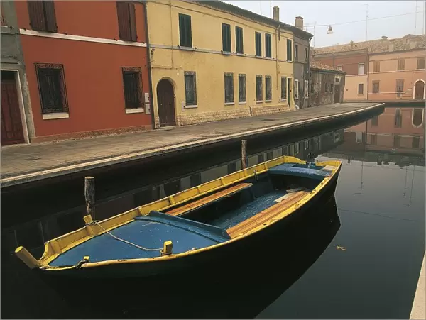 Italy, Emilia-Romagna Region, Comacchio (Ferrara Province), Po Delta Regional Park, Coloured batana boat along canal