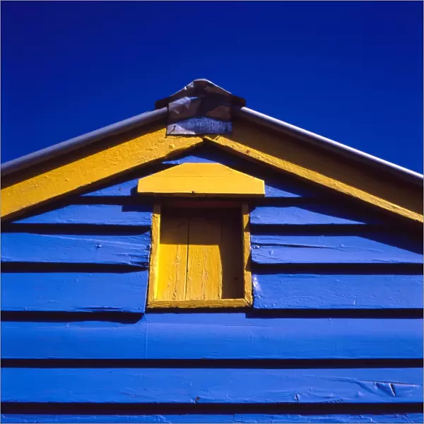 Blue and yellow painted building under blue sky