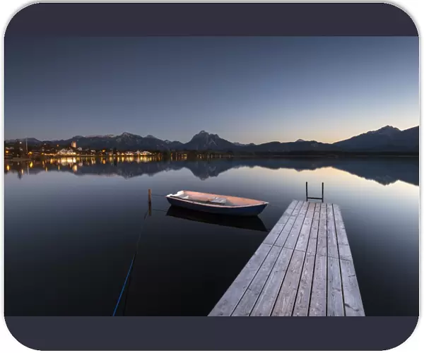 Evening light at Hopfensee Lake with jetty and rowing boat, Allgaeu Alps at back, Fuessen, Ostallgaeu region, Allgaeu, Bavaria, Germany, Europe