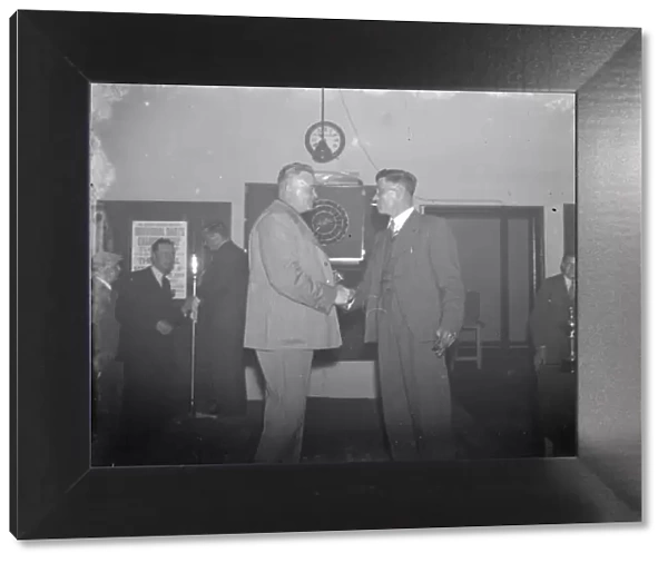Two men shake hands at the Erith Hospital darts competition. 1939