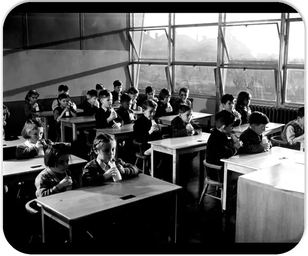 Children drinking milk at school. 1951