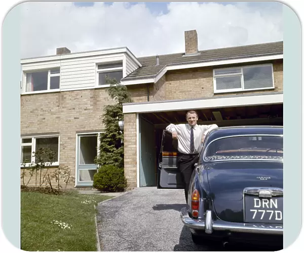 Chelsea manager Tommy Docherty at home with his car on the driveway May 1967