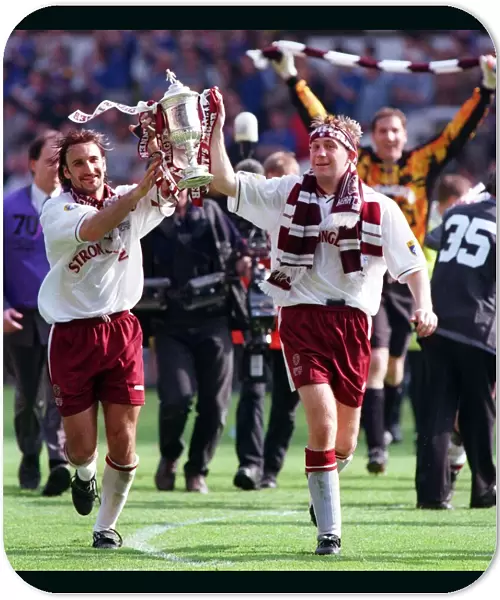 Heart of Midlothian footballer Jim Hamilton carries the Scottish Cup trophy around Celtic