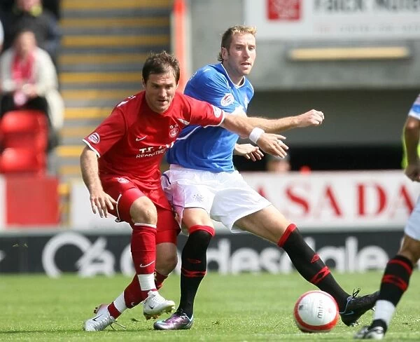 Aberdeen vs Rangers: A Tie at Pittodrie - Clash between Kirk Broadfoot and Jamie Smith in Clydesdale Bank Premier League Soccer