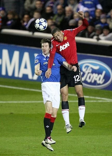 Aerial Clash: Smalling vs Broadfoot in Rangers vs Manchester United - UEFA Champions League Group C (Rangers 0-1 Manchester United)