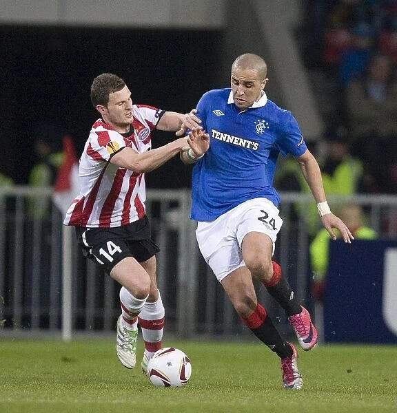 Battle at the Philips Stadion: Rangers Madjid Bougherra vs. PSV Eindhoven's Erik Pieters in the UEFA Europa League Round of 16 First Leg (0-0)