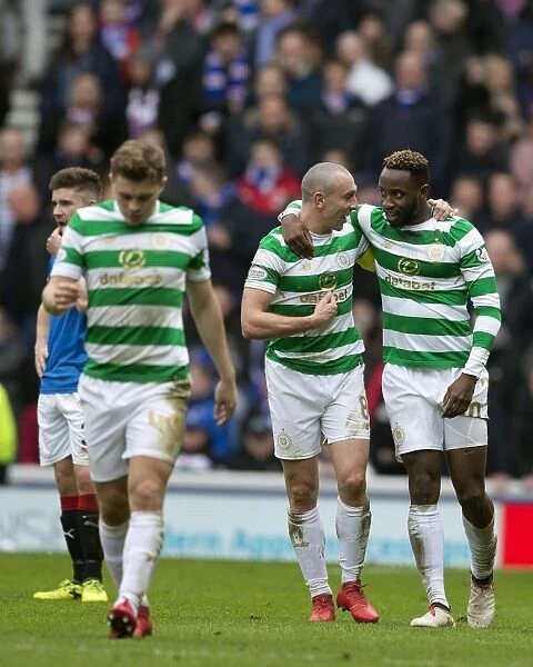 Celtic's Celebration: Dembele and Brown Rejoice at Ibrox after Goal in Rangers vs Celtic Match