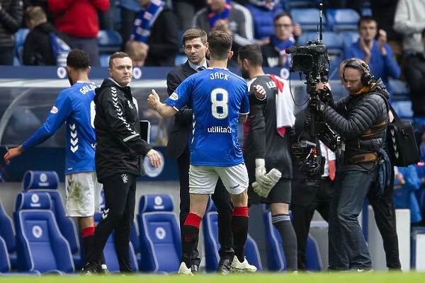 Champions Embrace: Steven Gerrard and Ryan Jack Share a Victory Handshake after Rangers Scottish Premiership Title Win