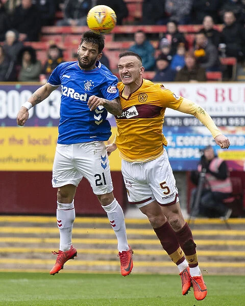 Clash at Fir Park: Candeias Soars Over Aldred