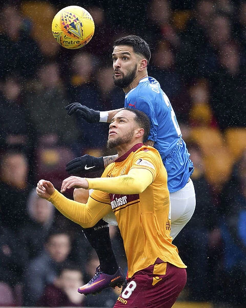 Clash at Fir Park: Leaping Duel between Rangers Daniel Candeias and Motherwell's Charles Dunne