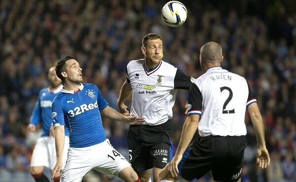 Clash at Ibrox: Rangers vs Inverness Caledonian Thistle - A Head-to-Head Battle in the Scottish League Cup: Intense Moment as Rangers Nicky Clark and Inverness Gary Warren Contend for Heading Supremacy (Scottish Cup Winners 2003)
