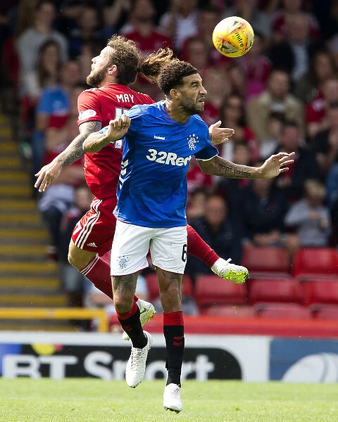 Clash at Pittodrie: Aerial Battle Between Goldson and May, Rangers vs. Aberdeen