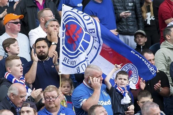 Euphoric Rangers Fans: Celebrating a Hard-Fought Victory Against Hamilton Academical in the Ladbrokes Premiership at Ibrox Stadium