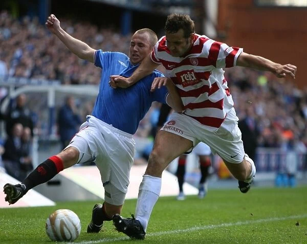 Intense Battle: Kenny Miller's Determined Fight for the Ball in Rangers Thrilling 4-1 Victory over Hamilton (Clydesdale Bank Premier League)