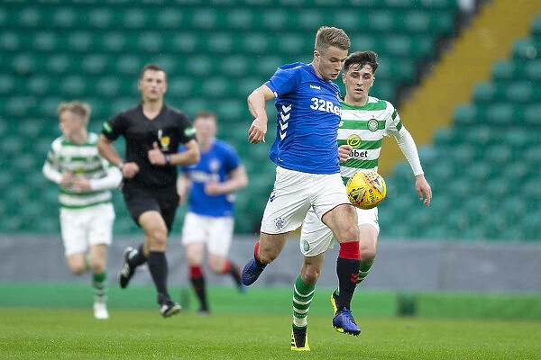Intense Battle for Possession: Andrew Dallas of Rangers Faces Off Against Celtic in the City of Glasgow Cup Final