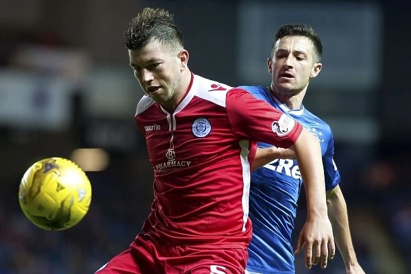 Intense Moment: Holt vs. Brownlie in Rangers vs. Queen of the South's Betfred Cup Quarterfinal Clash at Ibrox Stadium
