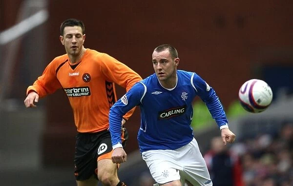 Intense Rivalry: Kris Boyd vs Michael Kovacevic - Rangers vs Dundee United Battle for Possession
