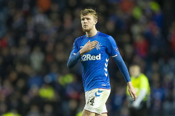 Joe Worrall's Emotional Moment: Touching the Rangers Badge after Europa League Victory at Ibrox Stadium