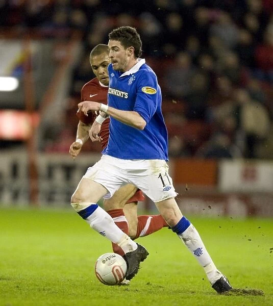 Kyle Lafferty's Winning Goal: Rangers Secure Victory Over Aberdeen in Scottish Premier League at Pittodrie Stadium