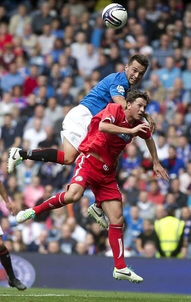 Leap for Glory: Rangers Chris Hegarty and Brechin City's Stuart Henderson Battle Mid-Air in SPFL League 1 (Rangers 4-1)