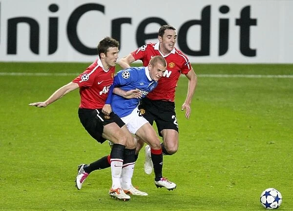 Manchester United's John O'Shea and Michael Carrick vs Rangers Vladimir Weiss: A Battle for Ball Possession in UEFA Champions League Group C