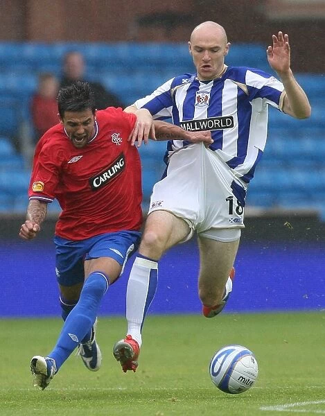 Nacho Novo vs Conor Sammon: A Tight Battle for the Ball in the Clydesdale Bank Premier League (0-0) at Rugby Park
