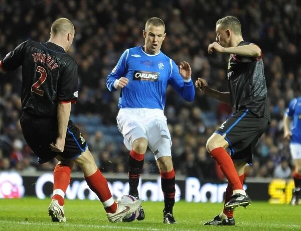 A Pivotal Moment: Kenny Miller vs Ross Tokley in the Clydesdale Bank Premier League Clash at Ibrox (1-0 in Favor of Inverness)