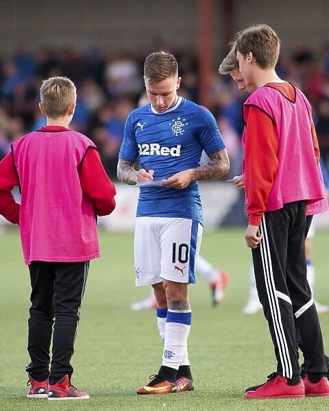 Rangers Barrie McKay Engages with Young Fans by Signing Balls at Ochilview Park