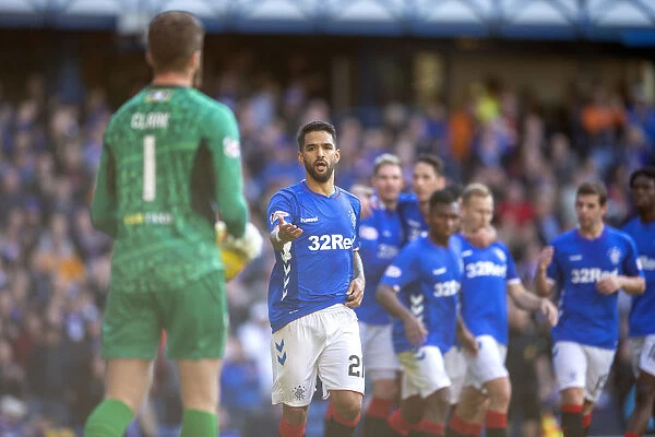 Rangers Daniel Candeias: Embracing Victory - Celebrating Goal with Match Ball at Ibrox Stadium