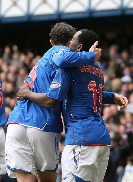Rangers Darcheville and Weir: A Jubilant Moment as They Celebrate Goal Against Hibernian at Ibrox