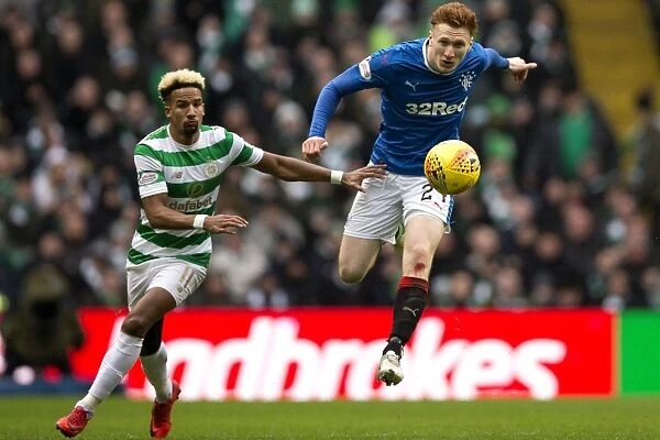 Rangers David Bates Clears Ball Against Celtic's Scott Sinclair in Intense Ladbrokes Premiership Clash