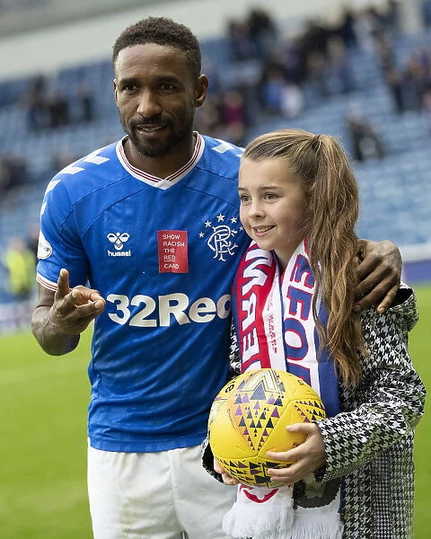 Rangers Defoe and Young Fan Amber Smith Share Hat-trick Moment at Ibrox Stadium