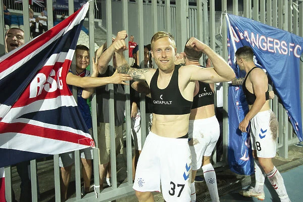 Rangers Europa League Triumph: Scott Arfield Embraces Jubilant Fans at Neftyanik Stadium