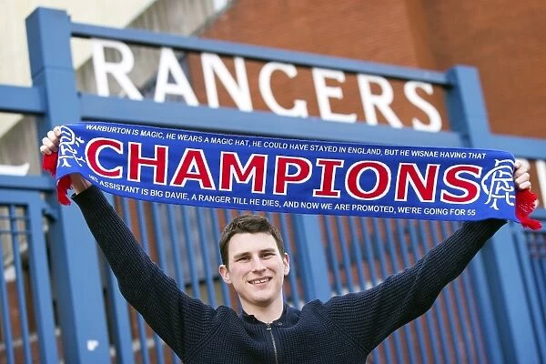 Rangers Fan Celebrates Championship Win with Champions Flag at Ibrox Stadium