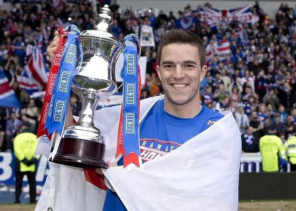 Rangers FC Claims Irn-Bru Scottish Third Division Title: Andy Little's Triumphant Moment with the Trophy at Ibrox Stadium