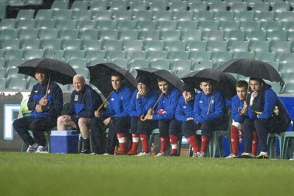 Rangers FC Weathering the Storm: Huddled Under Umbrellas at Sydney Football Stadium during Sydney Festival of Football 2010