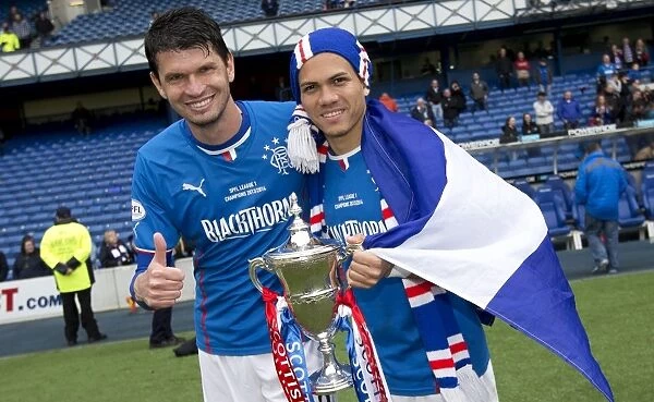 Rangers Football Club: Emilson Cribari and Arnold Peralta Celebrate Double Victory with the Scottish League One and Cup Trophies at Ibrox Stadium