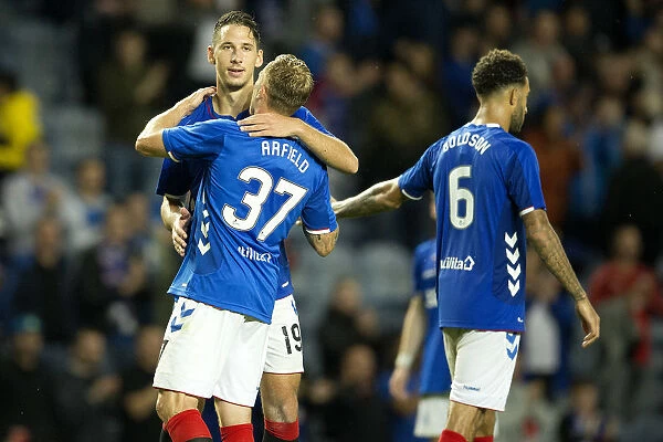 Rangers Football Club: Europa League Qualification Celebration - Nikola Katic and Scott Arfield's Triumphant Moment at Ibrox Stadium