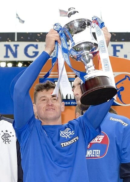 Rangers Football Club: Fraser Aird Celebrates Promotion to Third Division with Irn Bru Trophy Lift at Ibrox Stadium